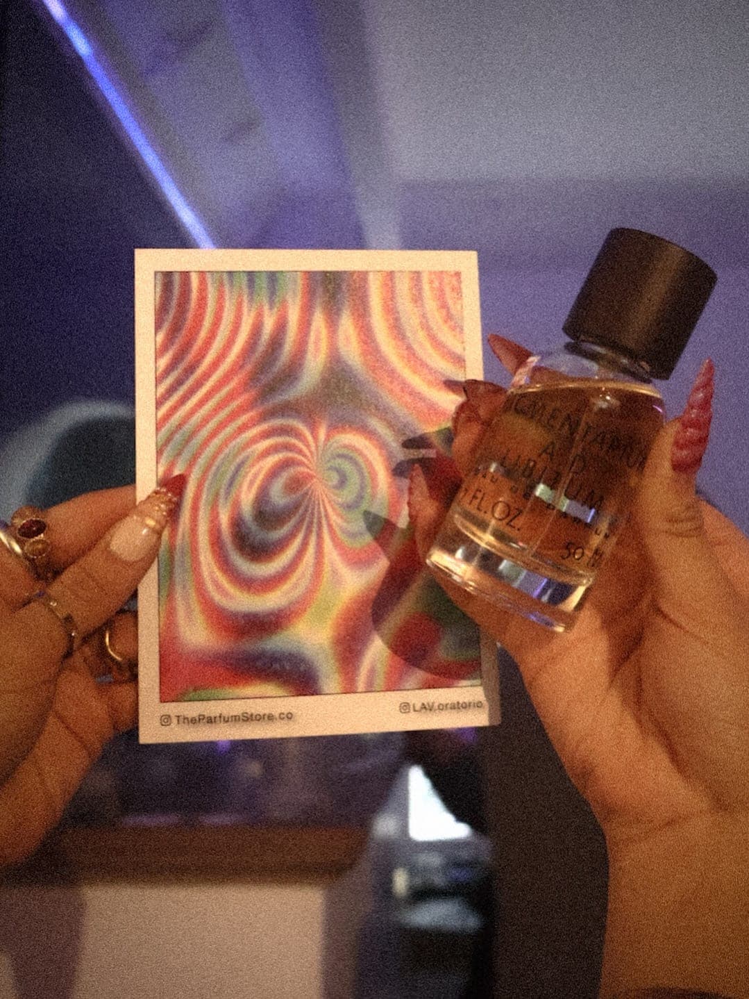 A guest holding their card next to the perfume that triggered it