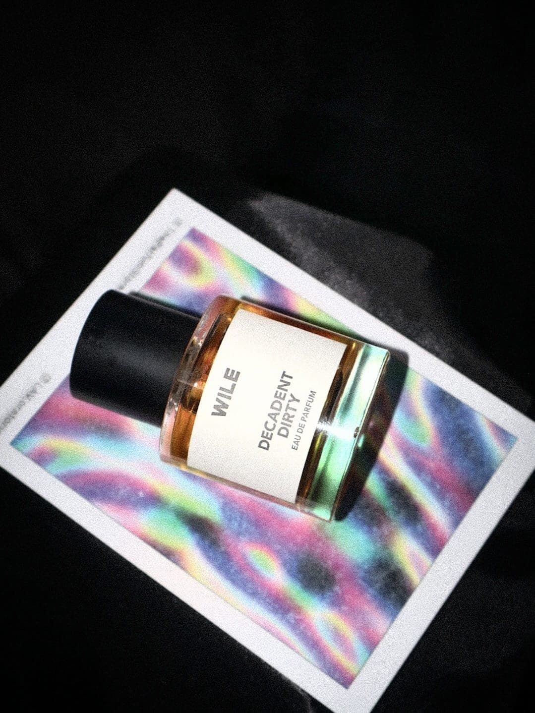 A bottle resting on one of the cards